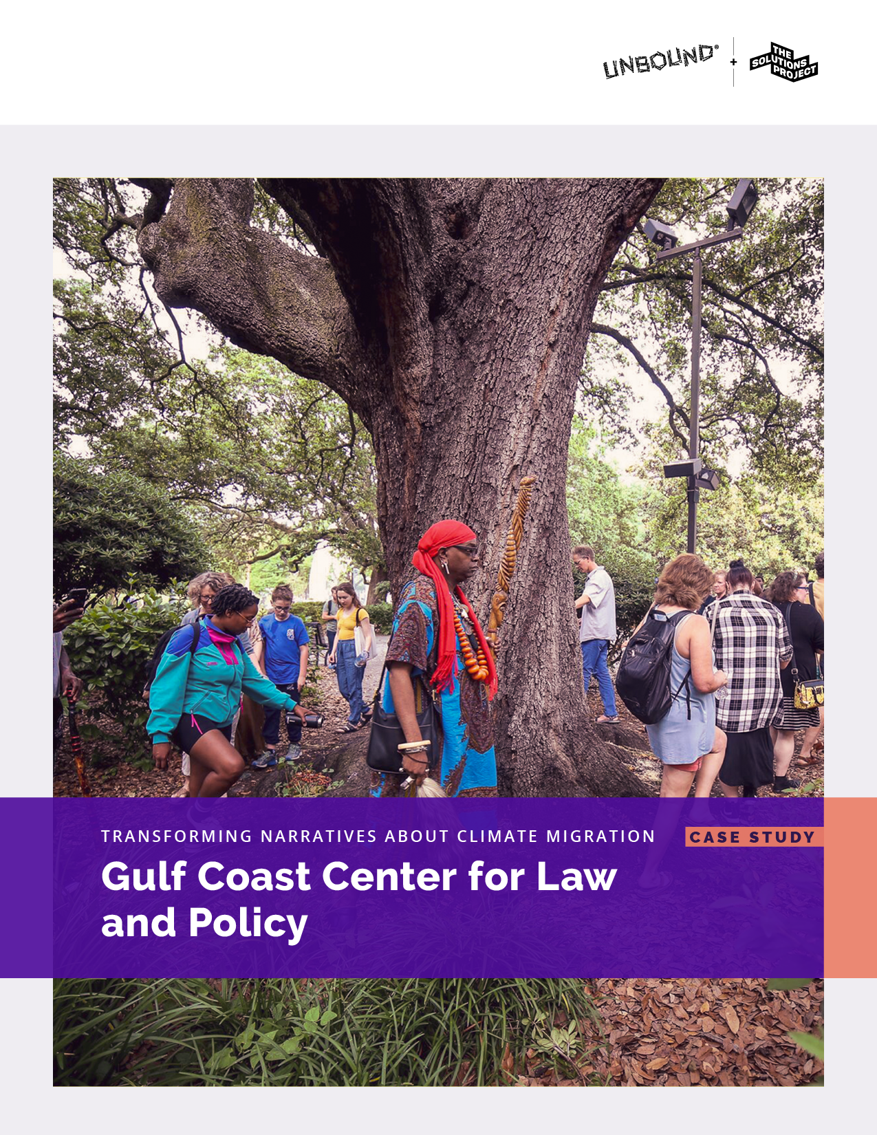 Several people around the truck of a large tree.